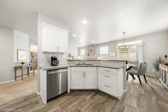 7919 W 55th Ave, Spokane, WA 99224 - kitchen with dishwasher, a sink, wood finished floors, a peninsula, and a chandelier