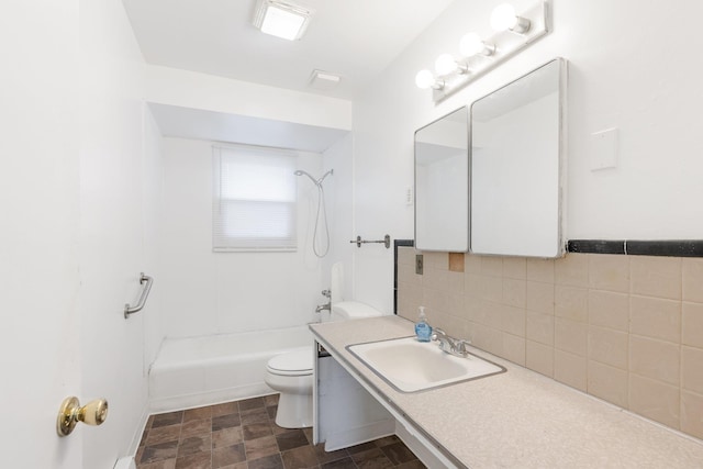 3013 E Broad Ave, Spokane, WA 99217 - full bathroom featuring toilet, decorative backsplash,  shower combination, vanity, and stone finish floors