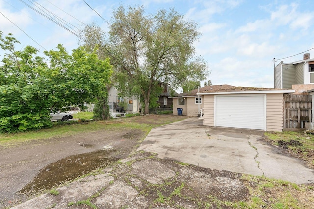 3013 E Broad Ave, Spokane, WA 99217 - view of front facade featuring fence, concrete driveway, and a garage