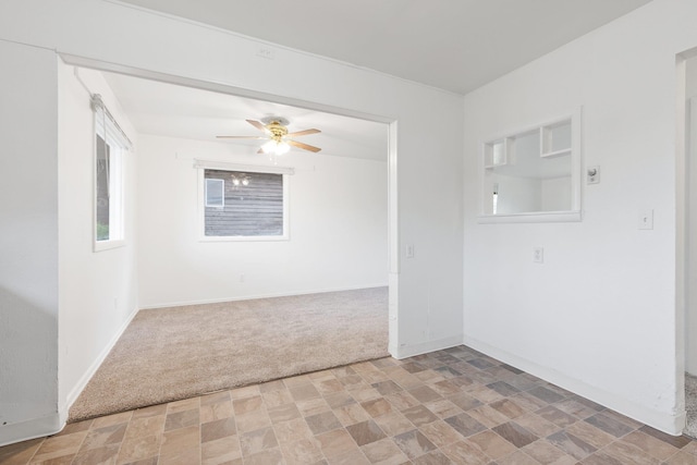 3013 E Broad Ave, Spokane, WA 99217 - empty room featuring light colored carpet, stone finish flooring, a ceiling fan, and baseboards