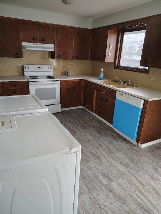 507 E Longfellow Ave, Spokane, WA 99207 - kitchen with dishwashing machine, washer / clothes dryer, white electric range, a sink, and under cabinet range hood