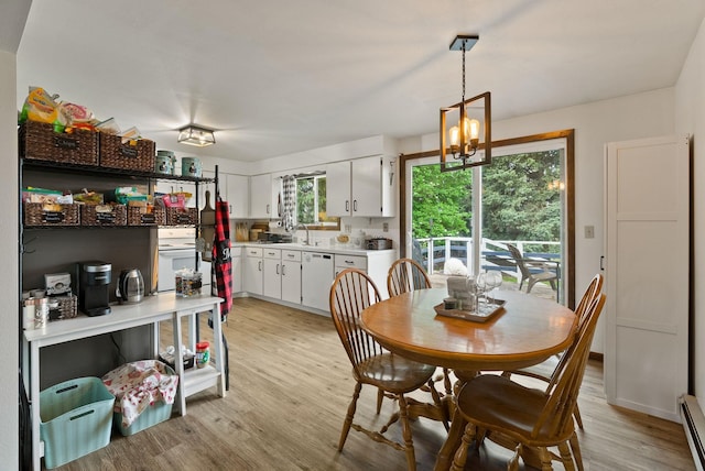 4509 N Murray Rd, Otis Orchards, WA 99027 - dining area featuring light wood finished floors, a chandelier, and a baseboard radiator