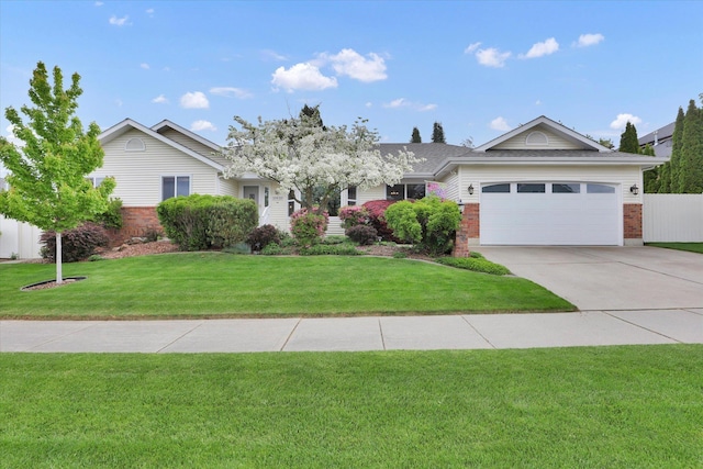 10610 N Iroquois Dr, Spokane, WA 99208 - ranch-style house featuring concrete driveway, an attached garage, a front yard, and brick siding
