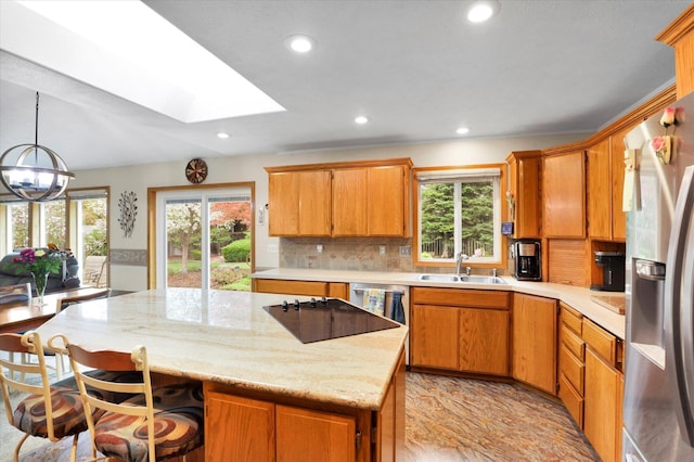 10610 N Iroquois Dr, Spokane, WA 99208 - kitchen featuring stainless steel fridge with ice dispenser, a skylight, a sink, plenty of natural light, and recessed lighting