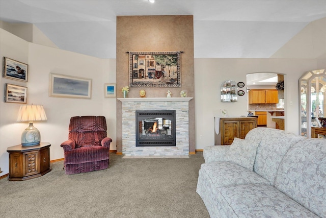 10610 N Iroquois Dr, Spokane, WA 99208 - living area with carpet, lofted ceiling, baseboards, a fireplace, and arched walkways