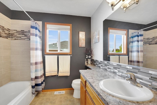 10610 N Iroquois Dr, Spokane, WA 99208 - full bath with healthy amount of natural light, toilet, decorative backsplash, and shower / bath combination with curtain