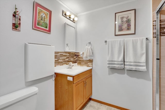 10610 N Iroquois Dr, Spokane, WA 99208 - bathroom featuring tasteful backsplash, ornamental molding, toilet, vanity, and a shower