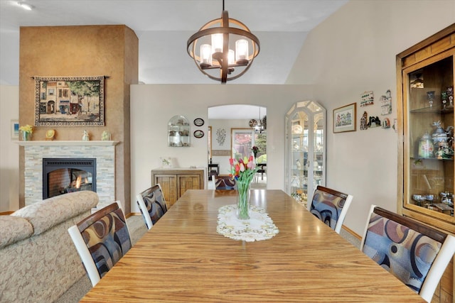 10610 N Iroquois Dr, Spokane, WA 99208 - dining area with a chandelier, arched walkways, and a stone fireplace
