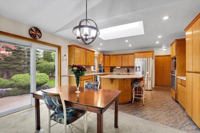 10610 N Iroquois Dr, Spokane, WA 99208 - dining room featuring recessed lighting, a skylight, a chandelier, and vaulted ceiling