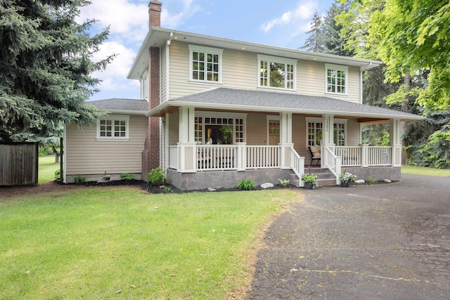 10204 N Wellen Ln, Spokane, WA 99218 - view of front of house featuring a chimney, a porch, a front lawn, and driveway