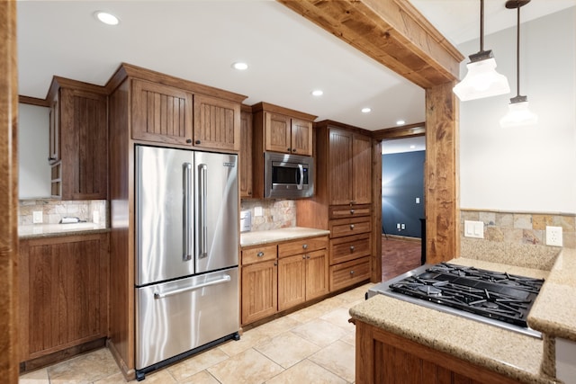 10204 N Wellen Ln, Spokane, WA 99218 - kitchen with stainless steel appliances, decorative backsplash, recessed lighting, light stone counters, and decorative light fixtures
