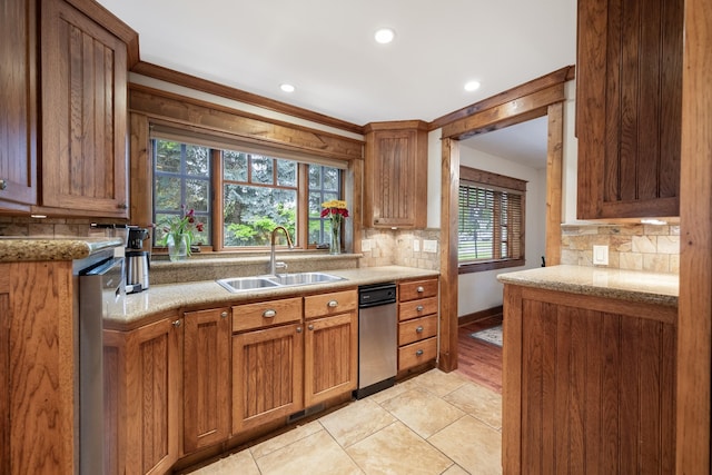 10204 N Wellen Ln, Spokane, WA 99218 - kitchen with a sink, decorative backsplash, recessed lighting, brown cabinets, and baseboards