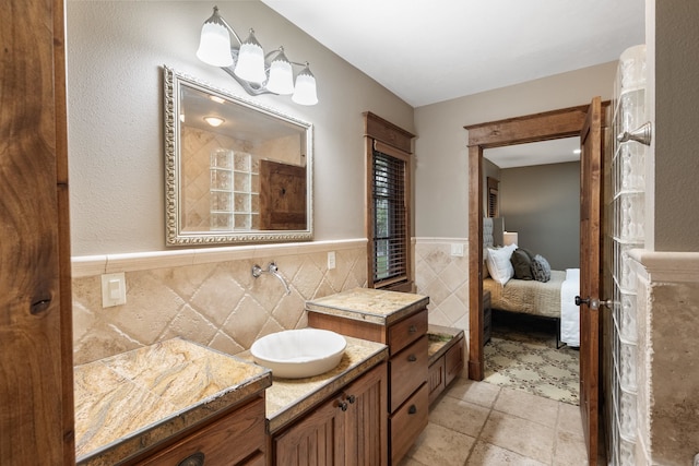 10204 N Wellen Ln, Spokane, WA 99218 - ensuite bathroom with tile walls, a wainscoted wall, and a sink