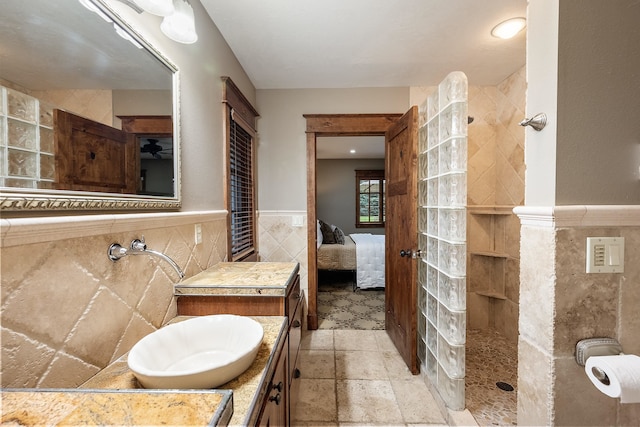 10204 N Wellen Ln, Spokane, WA 99218 - bathroom featuring tile walls, a walk in shower, vanity, a wainscoted wall, and ensuite bathroom