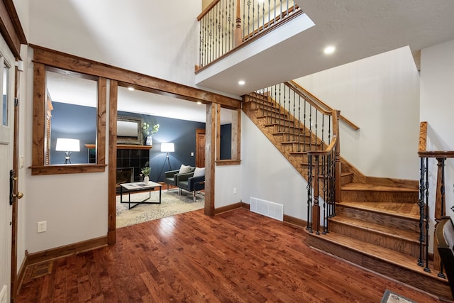 10204 N Wellen Ln, Spokane, WA 99218 - staircase featuring wood finished floors, baseboards, recessed lighting, and a high ceiling