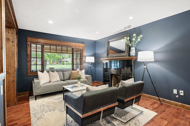 10204 N Wellen Ln, Spokane, WA 99218 - living room featuring baseboards, wood finished floors, recessed lighting, and a premium fireplace