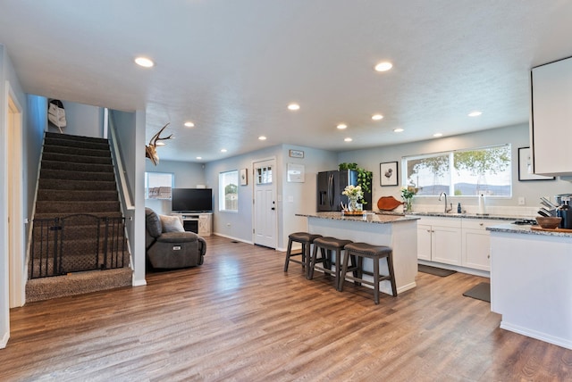 4521 E Fairview St, Spokane, WA 99217 - kitchen featuring stainless steel fridge with ice dispenser, a kitchen island, recessed lighting, white cabinets, and light stone countertops