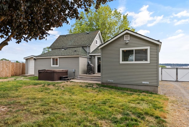 4521 E Fairview St, Spokane, WA 99217 - back of property featuring a hot tub and roof with shingles