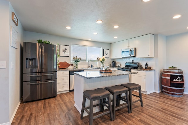 4521 E Fairview St, Spokane, WA 99217 - kitchen featuring appliances with stainless steel finishes, a sink, white cabinetry, light stone countertops, and recessed lighting