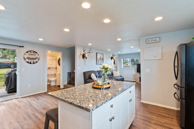 4521 E Fairview St, Spokane, WA 99217 - kitchen featuring freestanding refrigerator, white cabinetry, baseboards, wood finished floors, and recessed lighting