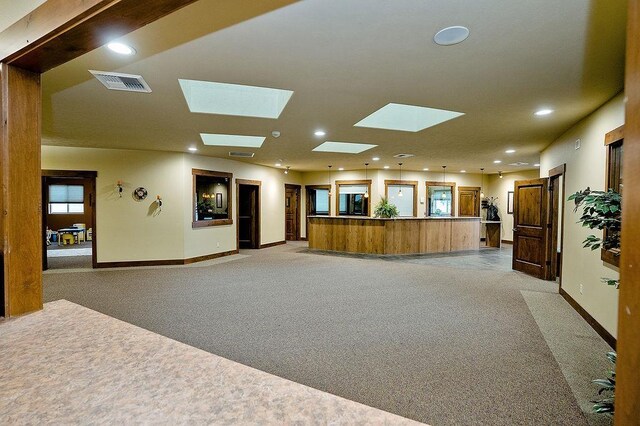 6701 N Idaho Rd, Newman Lake, WA 99025 - unfurnished living room featuring light carpet, baseboards, recessed lighting, and a skylight