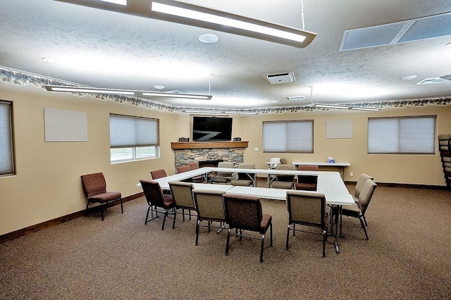 6701 N Idaho Rd, Newman Lake, WA 99025 - kitchen featuring carpet floors, a textured ceiling, a fireplace, and baseboards