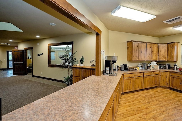 6701 N Idaho Rd, Newman Lake, WA 99025 - kitchen with light countertops, brown cabinets, recessed lighting, baseboards, and light wood-style flooring