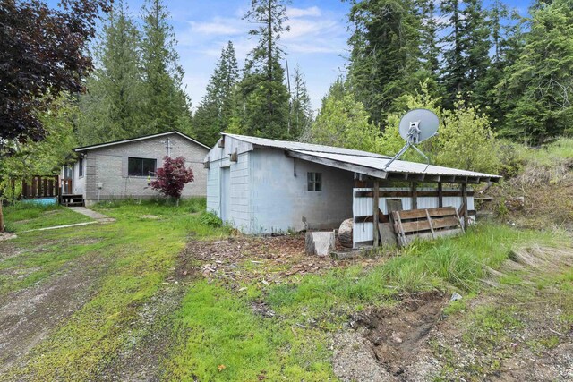 2362 Nicholson Rd, Elk, WA 99009 - rear view of house featuring concrete block siding and an outbuilding