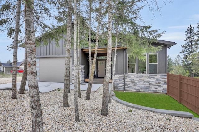 39980 Lake Summit Dr, Loon Lake, WA 99148 - mid-century home featuring board and batten siding, stone siding, driveway, and a garage