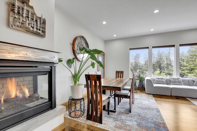39980 Lake Summit Dr, Loon Lake, WA 99148 - dining area with recessed lighting, wood finished floors, and a multi sided fireplace