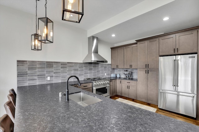 39980 Lake Summit Dr, Loon Lake, WA 99148 - kitchen featuring high end appliances, wall chimney exhaust hood, a sink, decorative backsplash, and recessed lighting