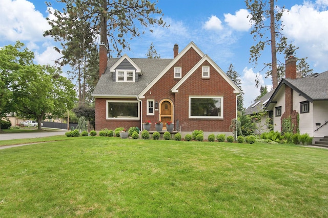1103 W 20th Ave, Spokane, WA 99203 - view of front of home featuring brick siding, a front lawn, a chimney, and roof with shingles