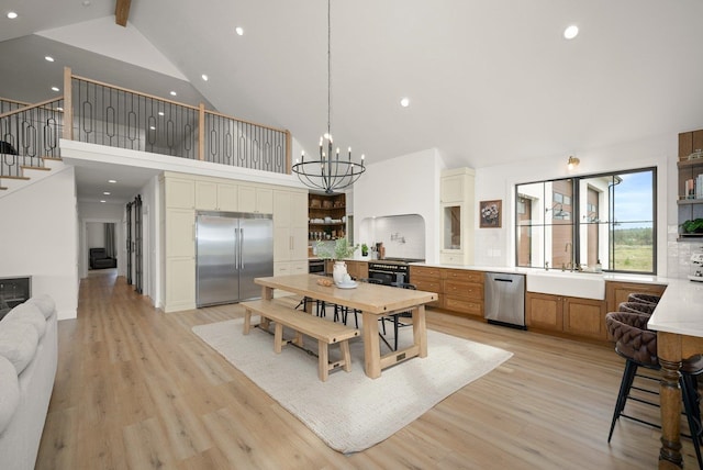 23114 W Mcfarlane Rd, Medical Lake, WA 99022 - dining space featuring high vaulted ceiling, beamed ceiling, light wood-style flooring, a chandelier, and recessed lighting
