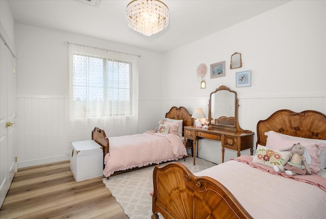 23114 W Mcfarlane Rd, Medical Lake, WA 99022 - bedroom featuring wood finished floors, a wainscoted wall, and a chandelier