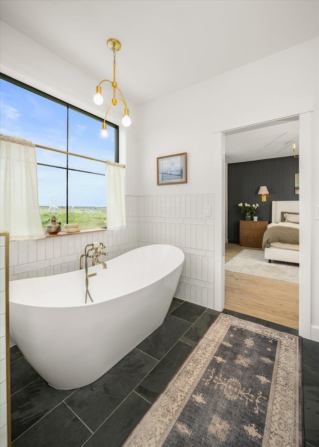 23114 W Mcfarlane Rd, Medical Lake, WA 99022 - ensuite bathroom with a freestanding bath, tile walls, and a wainscoted wall