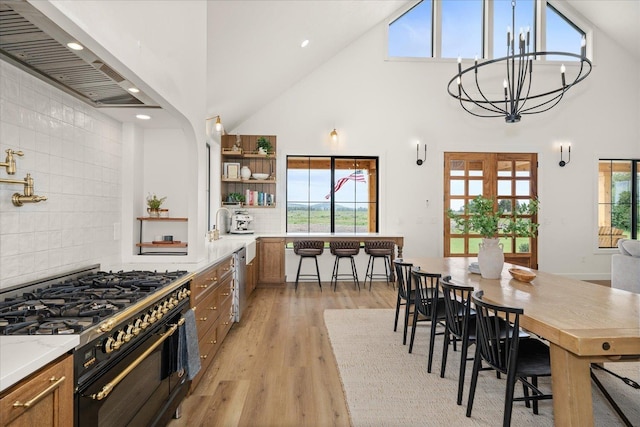 23114 W Mcfarlane Rd, Medical Lake, WA 99022 - kitchen with double oven range, a towering ceiling, premium range hood, open shelves, and light wood finished floors