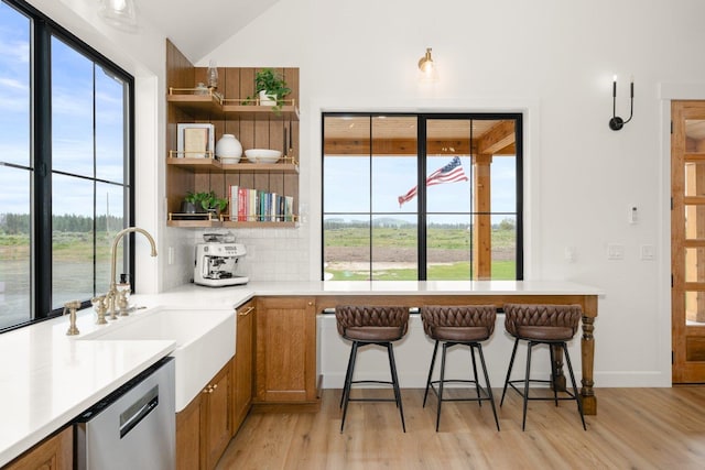 23114 W Mcfarlane Rd, Medical Lake, WA 99022 - kitchen with stainless steel dishwasher, open shelves, a sink, light wood-style floors, and lofted ceiling