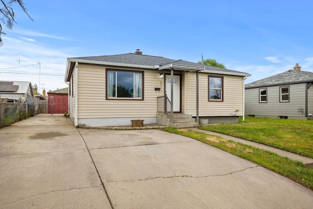 607 E Walton Ave, Spokane, WA 99207 - bungalow-style house featuring a chimney, concrete driveway, roof with shingles, and entry steps