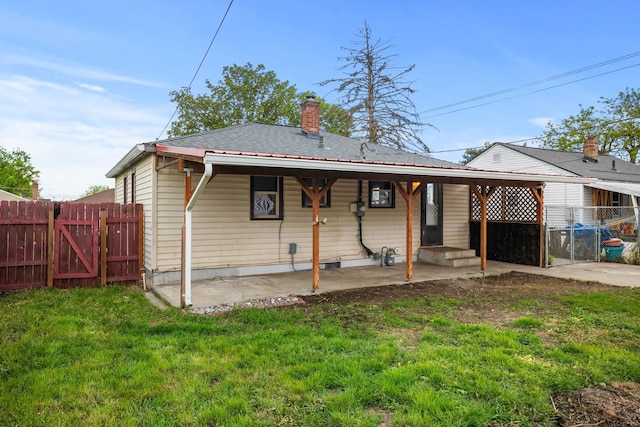 607 E Walton Ave, Spokane, WA 99207 - rear view of house with a gate, a patio area, and a chimney