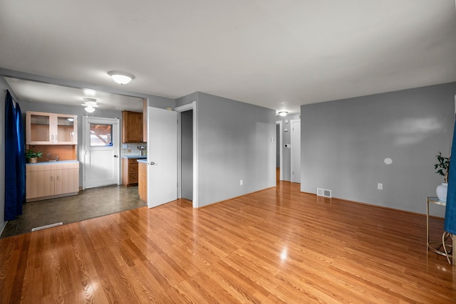607 E Walton Ave, Spokane, WA 99207 - unfurnished living room with light wood finished floors