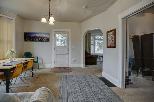 1608 E Pacific Ave, Spokane, WA 99202 - carpeted entrance foyer with arched walkways, a chandelier, and baseboards
