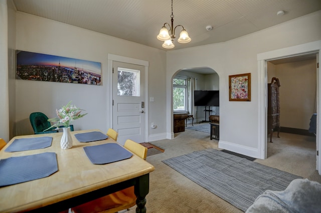 1608 E Pacific Ave, Spokane, WA 99202 - dining area with arched walkways, light colored carpet, a chandelier, and baseboards