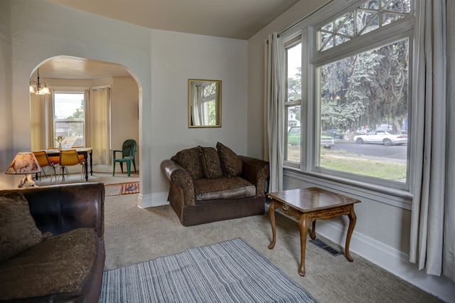 1608 E Pacific Ave, Spokane, WA 99202 - living room with arched walkways, carpet, plenty of natural light, and baseboards