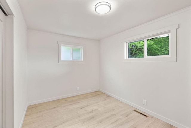 2417 E Nebraska Ave, Spokane, WA 99208 - spare room featuring healthy amount of natural light, wood finished floors, crown molding, and baseboards