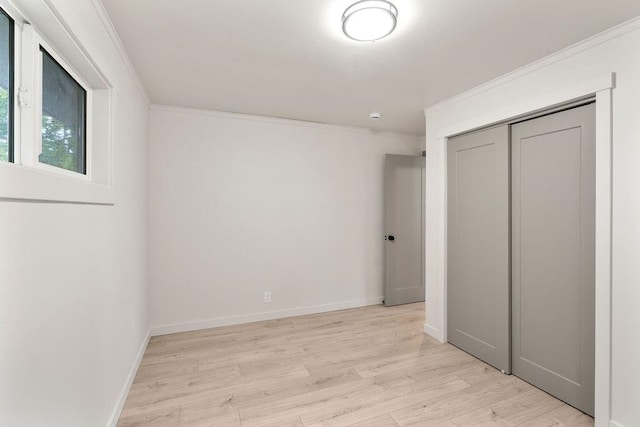 2417 E Nebraska Ave, Spokane, WA 99208 - unfurnished bedroom featuring crown molding, light wood finished floors, a closet, and baseboards
