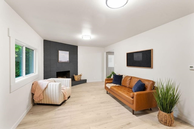 2417 E Nebraska Ave, Spokane, WA 99208 - living area with baseboards, light wood-style floors, and a brick fireplace