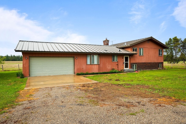 4796 W Gibson Dahl Rd, Clayton, WA 99110 - view of front of home featuring driveway, a front lawn, a chimney, and an attached garage