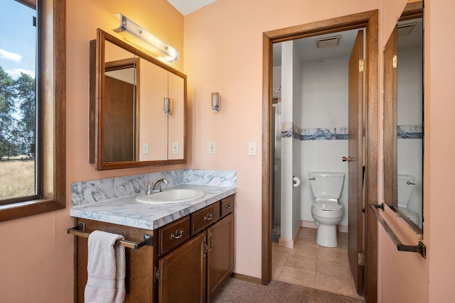 4796 W Gibson Dahl Rd, Clayton, WA 99110 - bathroom with vanity, healthy amount of natural light, toilet, and tile patterned flooring