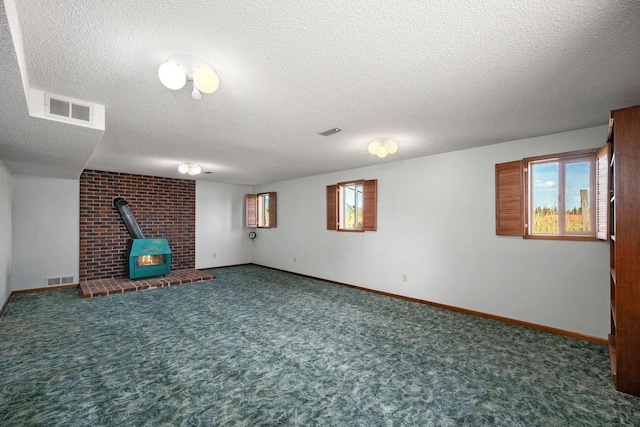 4796 W Gibson Dahl Rd, Clayton, WA 99110 - basement featuring a wood stove, carpet floors, a textured ceiling, and baseboards
