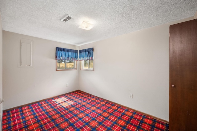 4796 W Gibson Dahl Rd, Clayton, WA 99110 - empty room with a textured ceiling, baseboards, and tile patterned floors